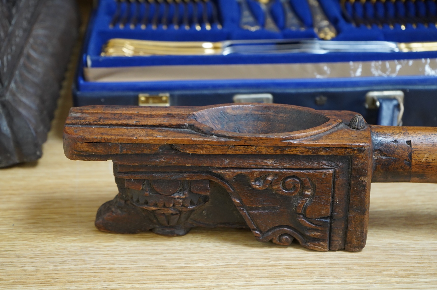 An 18th / 19th century Indian carved wood oil pourer, 43cm